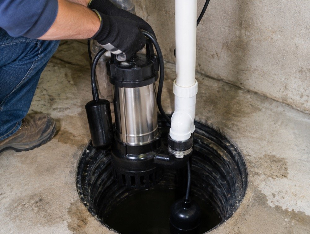 Technician replacing an old sump pump in Cleveland